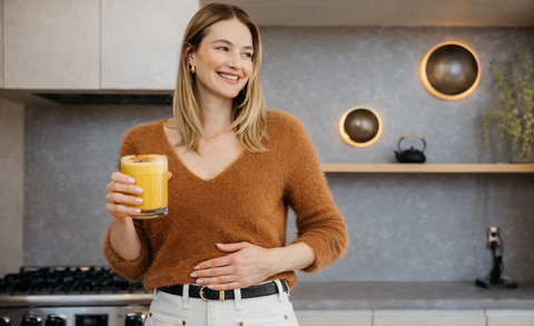 Chica bebiendo cúrcuma latte